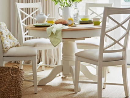Dining table and chairs on natural flooring.